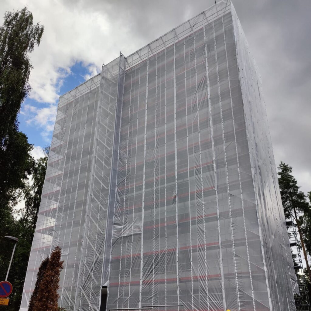 Frame scaffolding EURO+ on construction site covered with safety nets